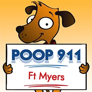 POOP 911 Ft Myers, Florida yard sign being held by a Smiling Brown Dog.