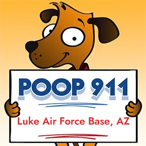POOP 911 Luke Air Force Base, Arizona yard sign being held by a Smiling Brown Dog.