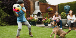 Family playing footloose and worry free in yard because of POOP 911 pooper scooper service